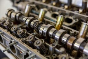 Detailed view of camshaft inside an engine block illustrating mechanical engineering.